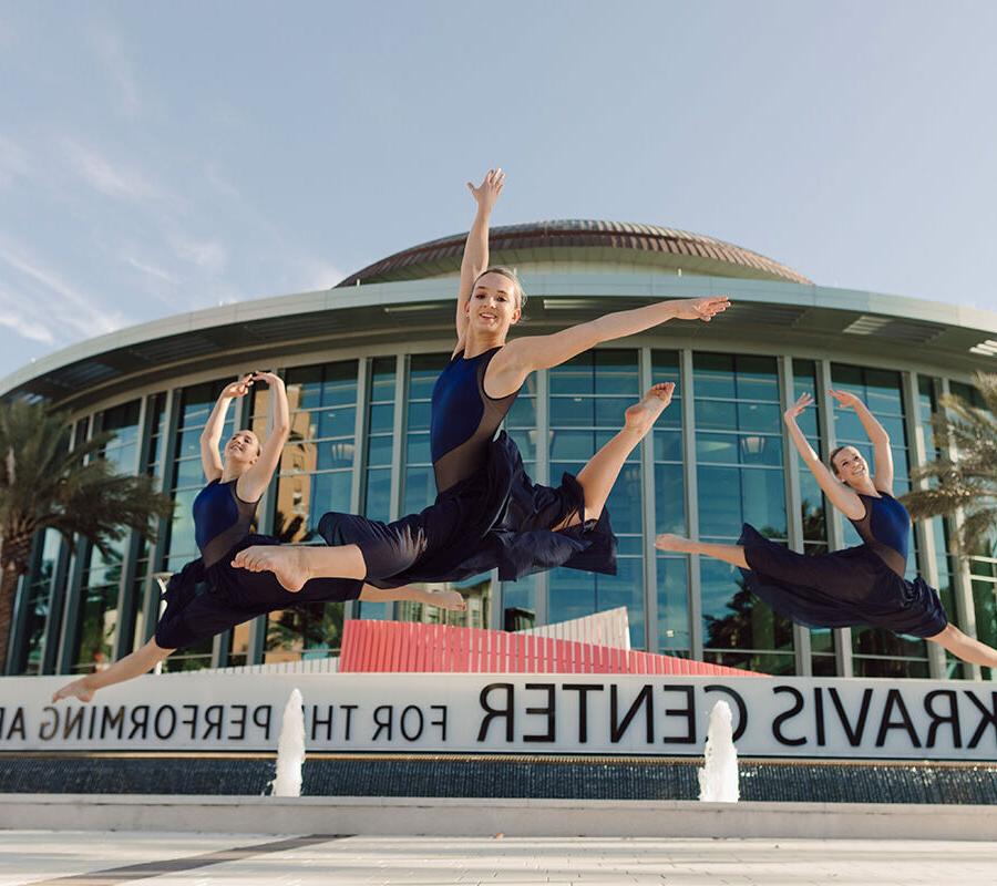 Three dance students perform outside the Kravis Center.